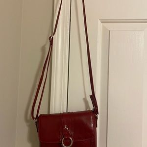 Small burgundy purse, on the purse it says genuine leather